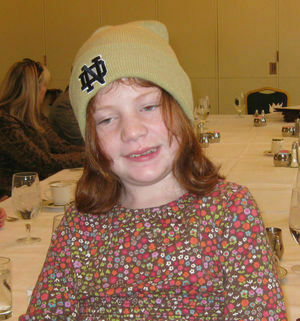 Young girl with red hair wearing an ND monagramed wool hat