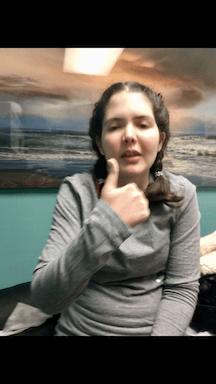 Teen girl giving a thumbs up sign